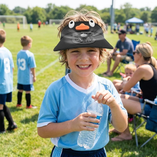 Child wearing sun visor hat with cooling fan at summer sports event